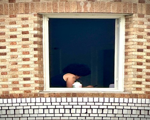 person taking a break looking out of the window far away